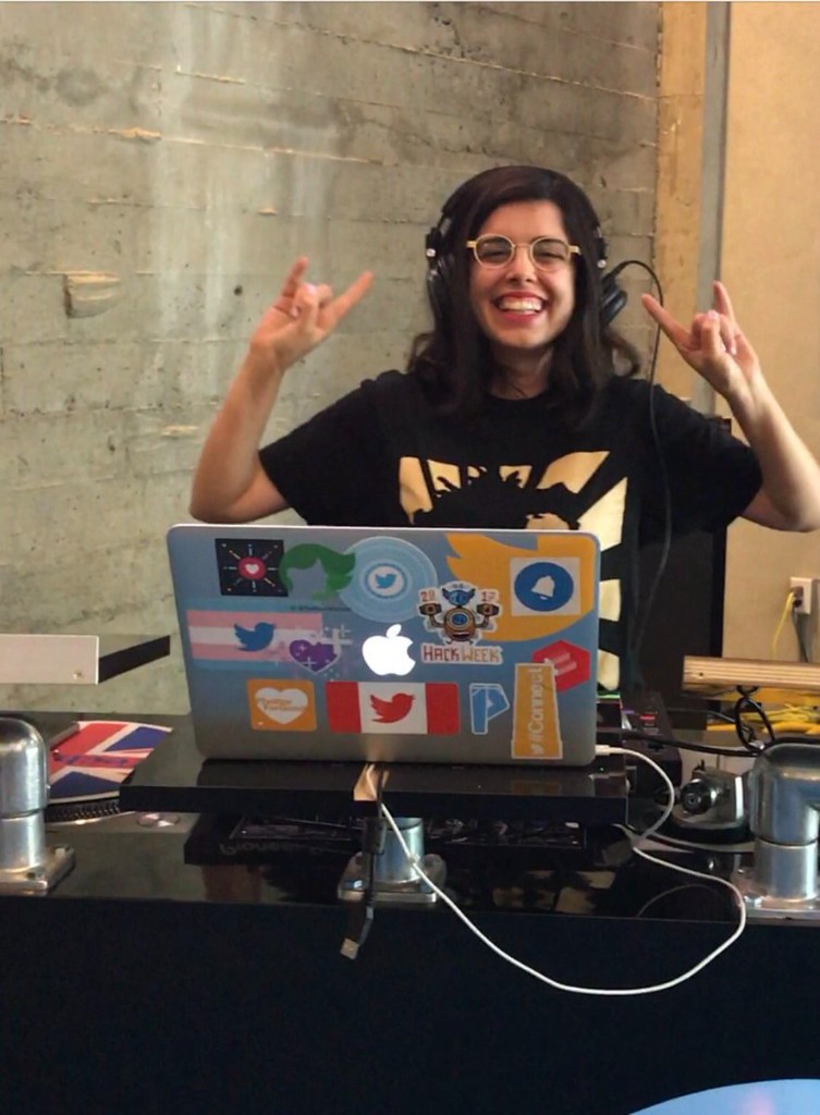 Pardis DJing with headphones and a laptop